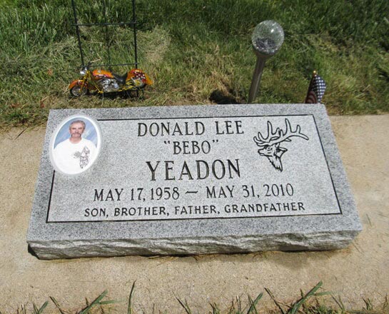Grey granite bevel marker with a porcelain portrait and an etched elk