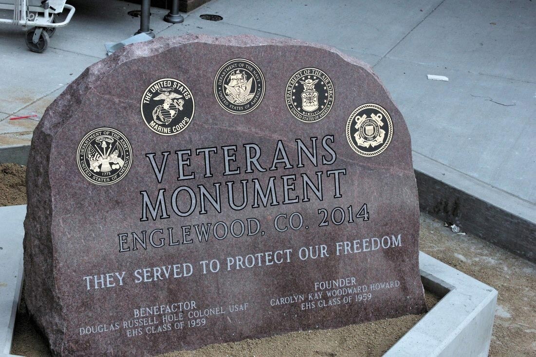The Englewood Colorado Veterans Monument, a natural faced red stone carrying the seals of the five services