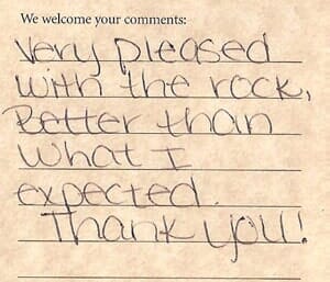A short handwritten comment card about being pleased with a rock